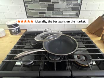 A nonstick frying cookware with a solid lid rests connected a stovetop. A canister labeled