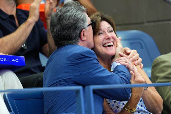 Stephen Colbert kisses his wife at a tennis game