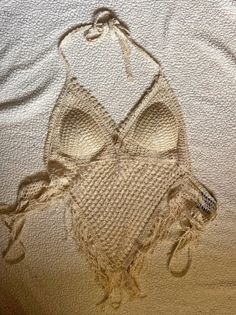 Crochet halter apical  with fringe detailing, laid level  connected  a textured surface