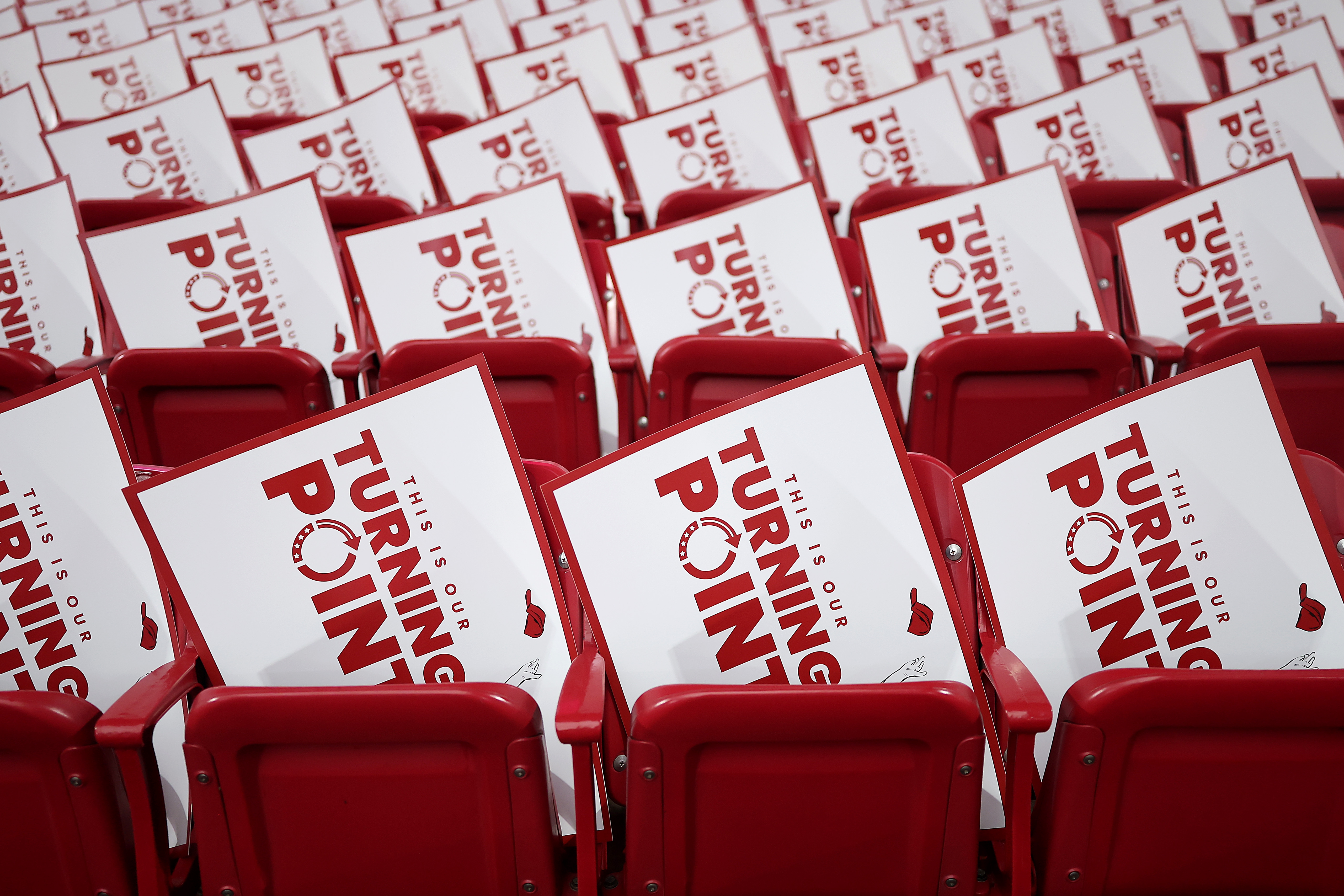 Rows of red seats filled with signs reading "This Is Your Turning Point."