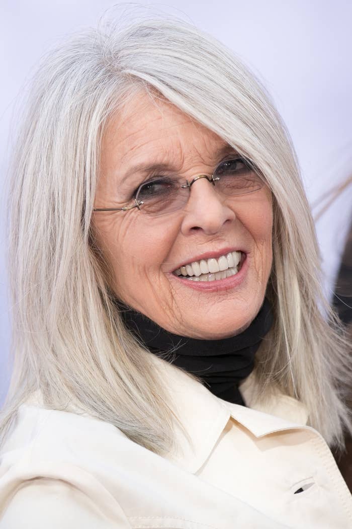 Diane Keaton with long hair and sunglasses, smiling at an event