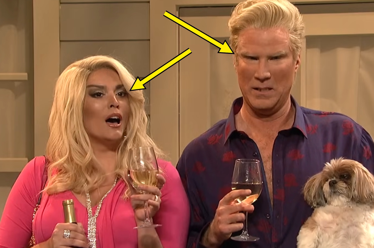 Two people holding wine glasses, one also holding a small dog. Both wear stylish clothing, possibly at a social gathering or event