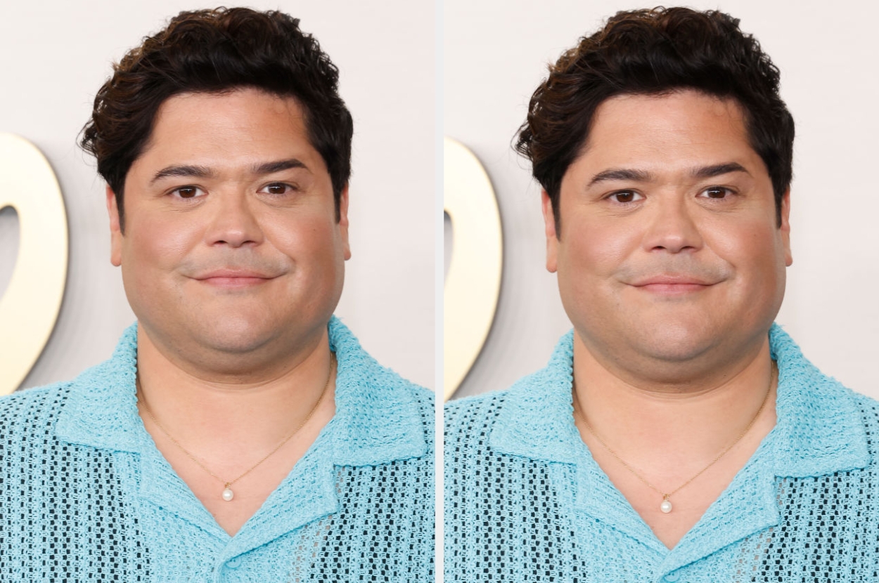 Person in a textured outfit with short hair, wearing a necklace, poses for a photo at an event