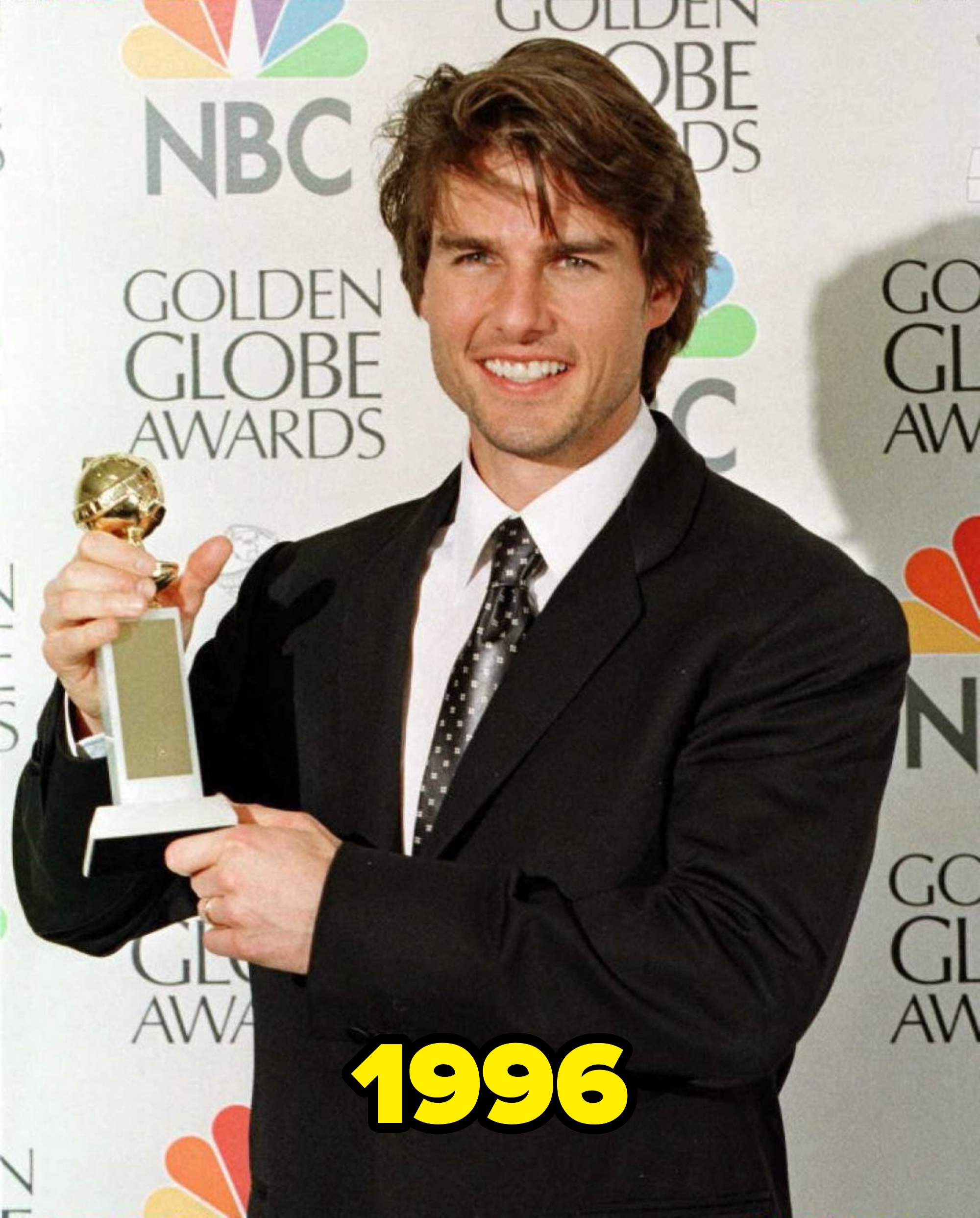 Tom Cruise holding a Golden Globe award in 1996