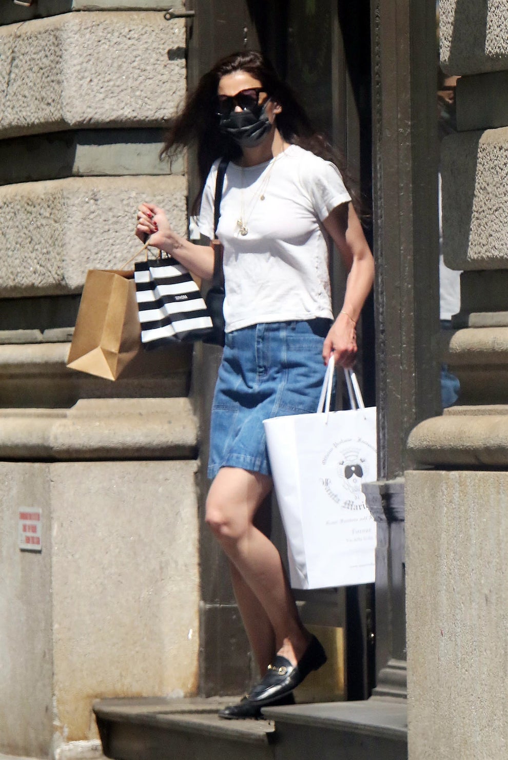 21 Low-Key Ridiculous Things Celebs Did For Money, Clout, Or Attention 96 Katie in casual outfit with denim skirt and t-shirt, holding branded shopping bags, walking outside a building