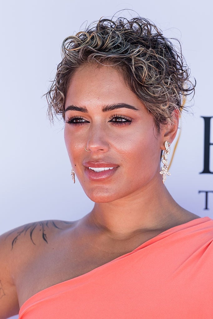 21 Low-Key Ridiculous Things Celebs Did For Money, Clout, Or Attention 100 Malin on red carpet in one-shoulder gown, wearing elegant earrings, looking at the camera