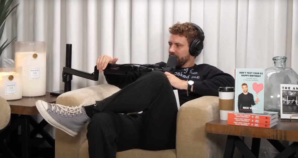 21 Low-Key Ridiculous Things Celebs Did For Money, Clout, Or Attention 76 NIck seated and holding his giant mic