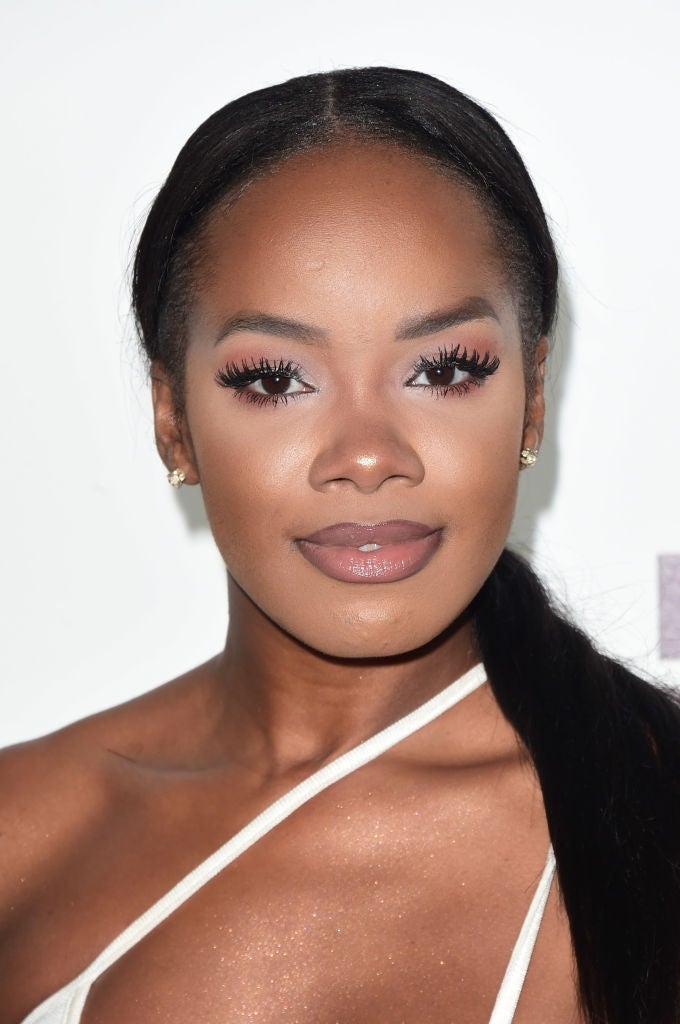 21 Low-Key Ridiculous Things Celebs Did For Money, Clout, Or Attention 106 Rachel with long hair in a sleek ponytail, wearing a strappy top and subtle makeup with prominent eyelashes, smiles at the camera on red carpet