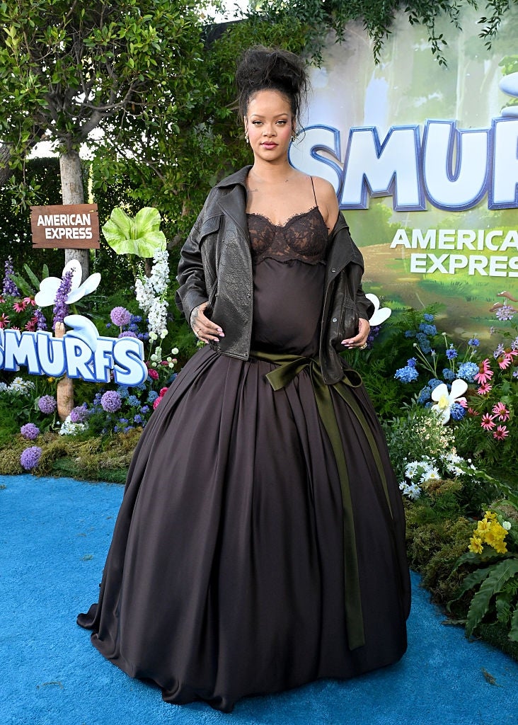 21 Low-Key Ridiculous Things Celebs Did For Money, Clout, Or Attention 92 Rihanna in lace top and voluminous skirt on a red carpet at a Smurfs event