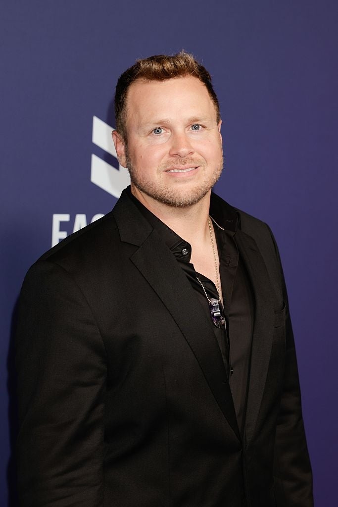 21 Low-Key Ridiculous Things Celebs Did For Money, Clout, Or Attention 40 Spencer in a dark suit on a red carpet, facing the camera with a slight smile