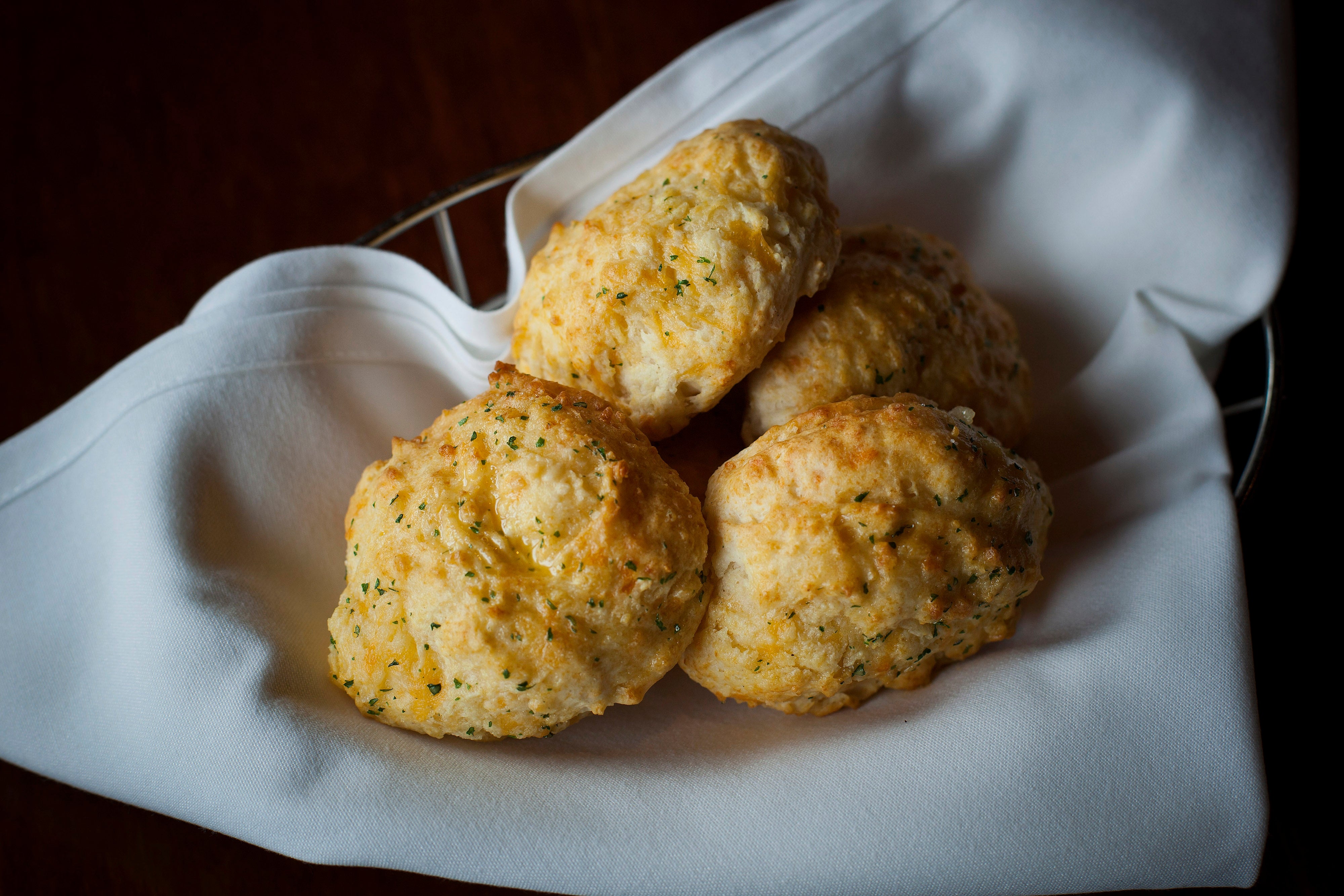 Four biscuits with a crumbly texture beryllium   connected  a achromatic  napkin, suggesting a freshly baked and appetizing look