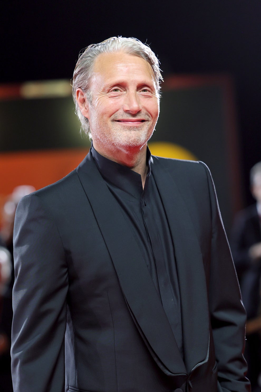 21 Jaw-Dropping "Then And Now" Photos Of Celebrities Who Have Gotten Wayyyyy Sexier With Age 14 Smiling man in a sleek black suit on a red carpet