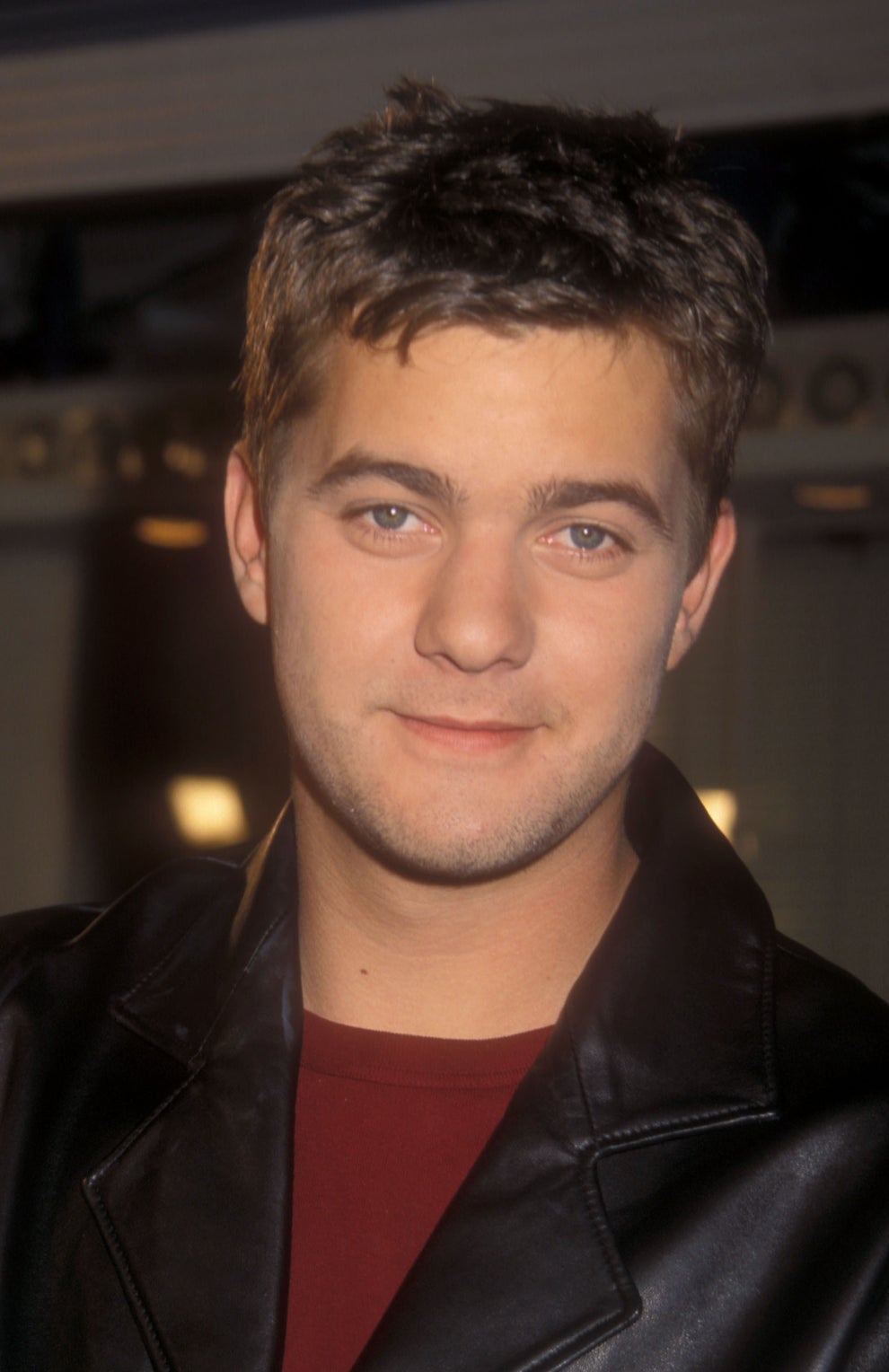 21 Jaw-Dropping "Then And Now" Photos Of Celebrities Who Have Gotten Wayyyyy Sexier With Age 8 Person in a leather jacket, looking at the camera, with a slight smile