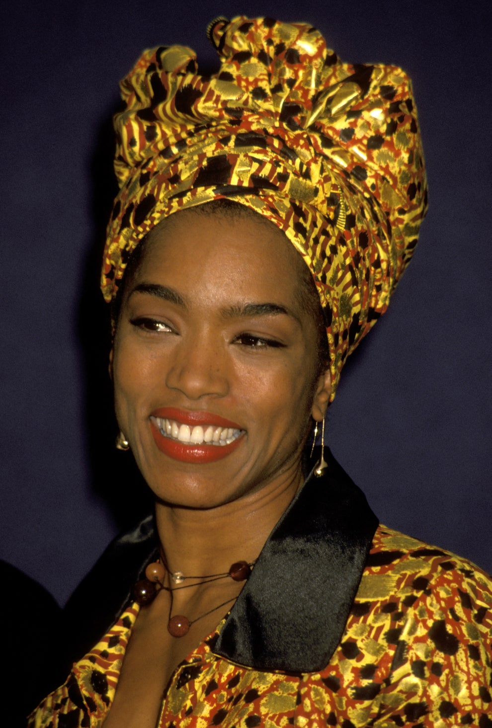 21 Jaw-Dropping "Then And Now" Photos Of Celebrities Who Have Gotten Wayyyyy Sexier With Age 20 Person smiling, wearing a patterned headwrap and matching outfit