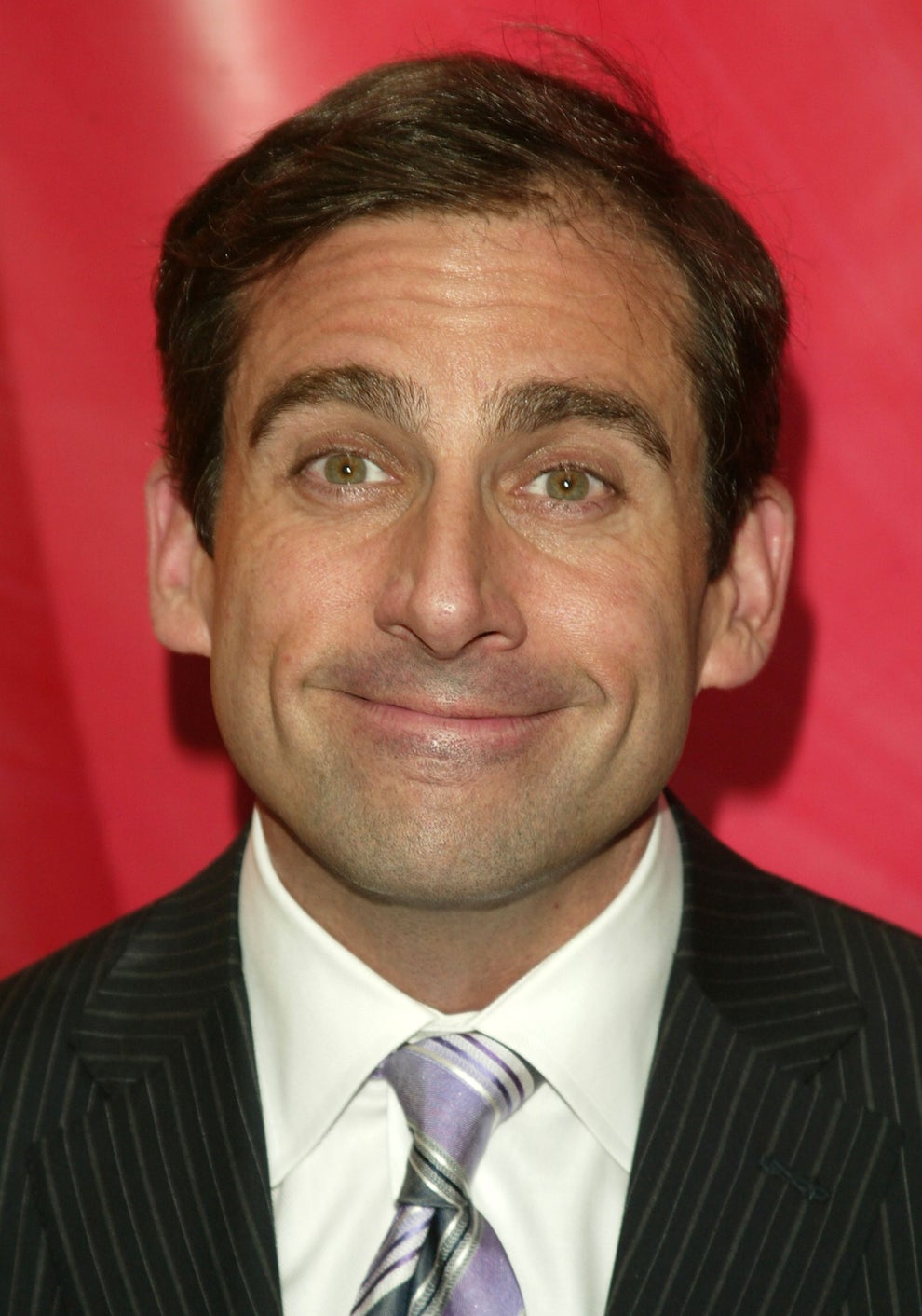 21 Jaw-Dropping "Then And Now" Photos Of Celebrities Who Have Gotten Wayyyyy Sexier With Age 40 I don't know who this is. A person smiling in a pinstripe suit with purple tie against an abstract red background