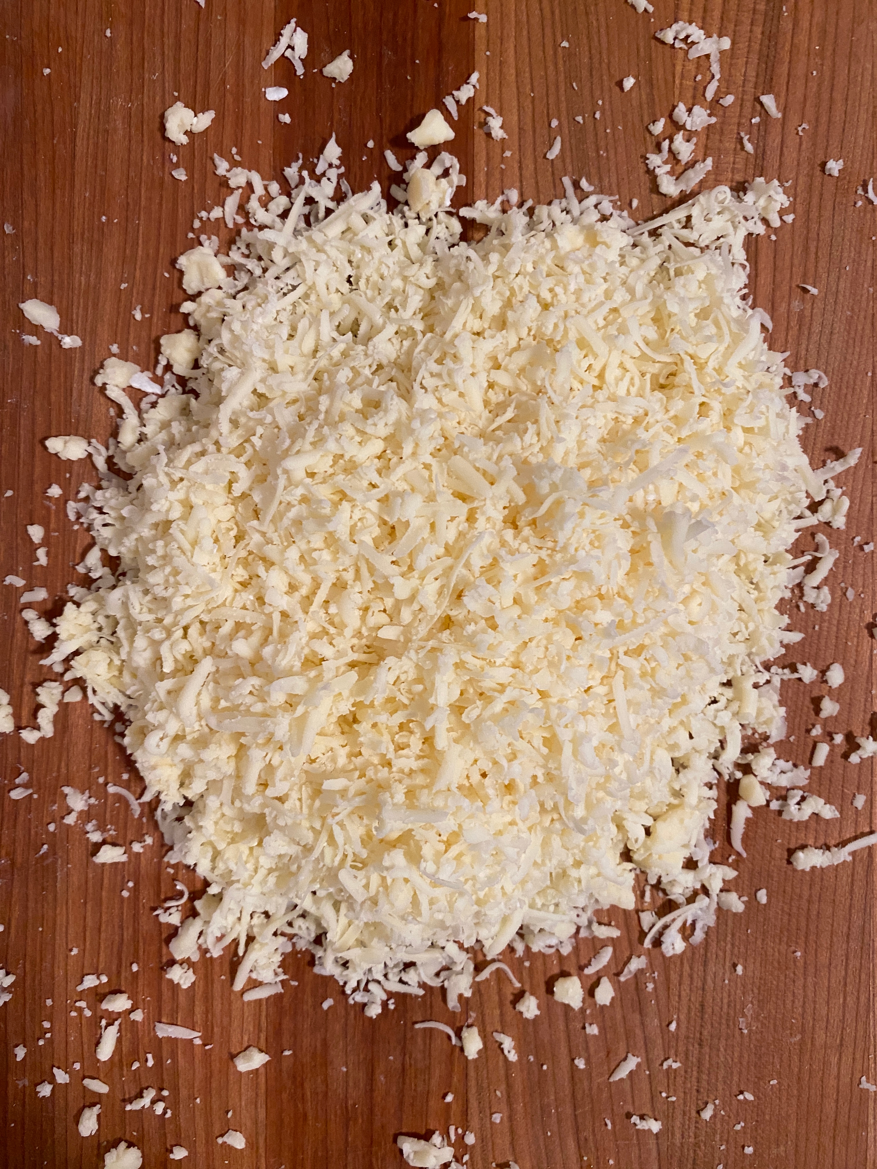 Shredded cheese spread on a wooden surface