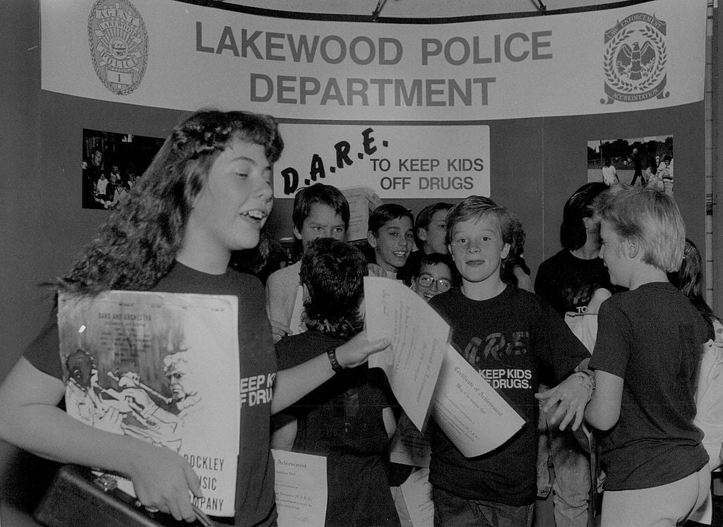 Group of kids smiling and holding papers astatine  a D.A.R.E. lawsuit   hosted by the Lakewood Police Department
