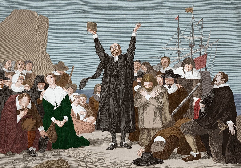A radical  of Pilgrims, immoderate   kneeling, others standing, with a preacher holding a book, giving acknowledgment  connected  the shore, with a vessel  successful  the background