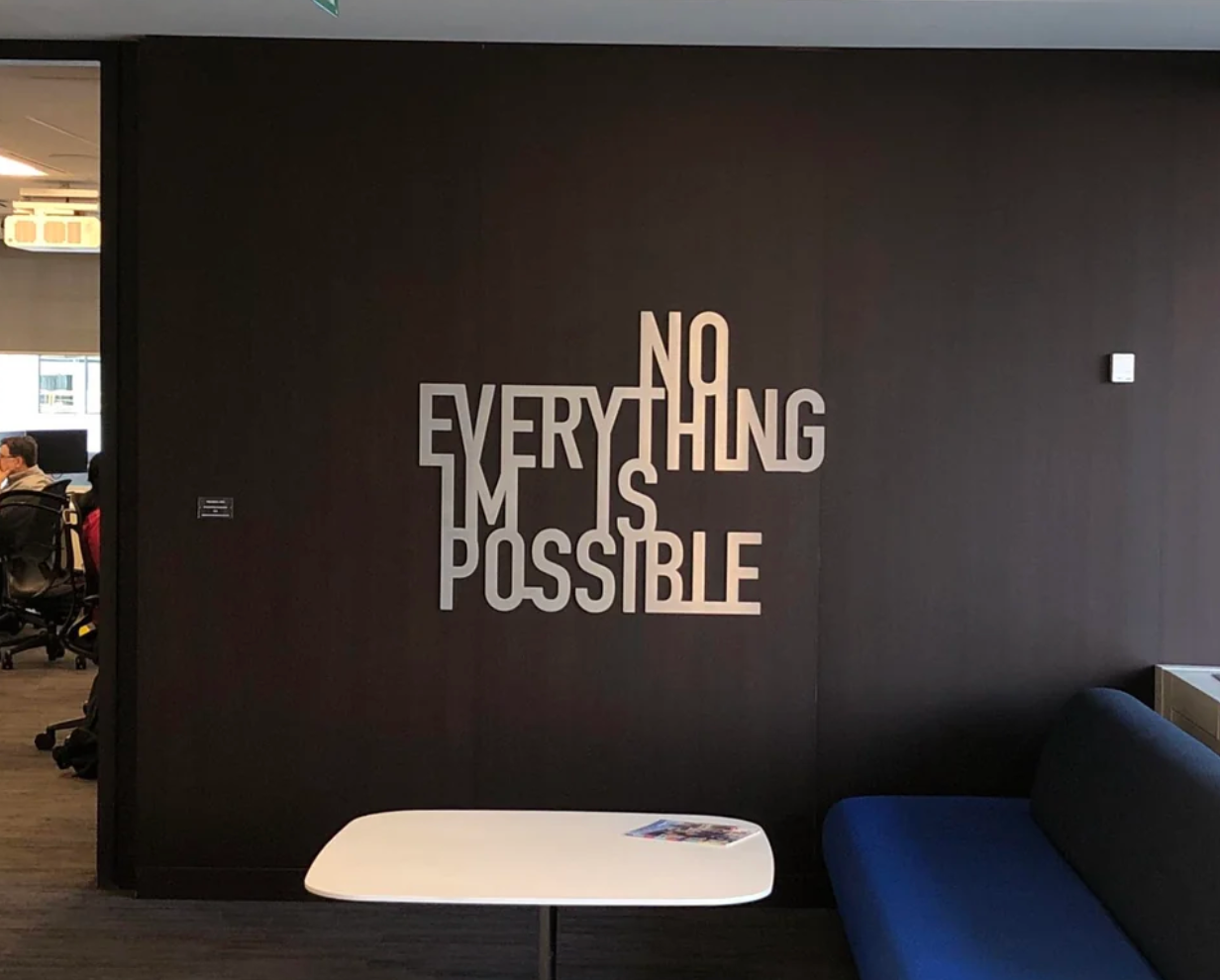 Text art on a wall reads "Nothing is impossible" and "Everything is possible," using overlapping letters for a visual effect