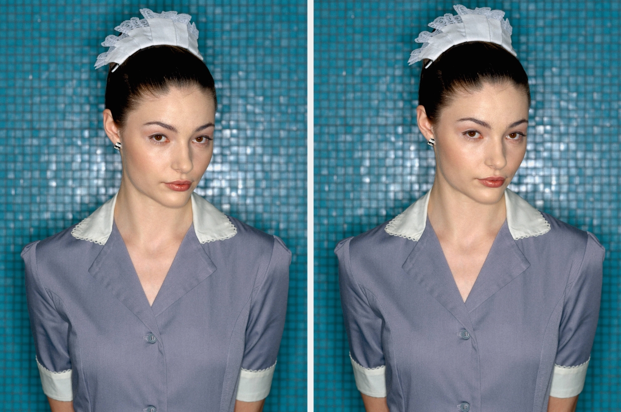 Person wearing a uniform with lace headpiece, standing in front of a tiled background, looking directly at the camera