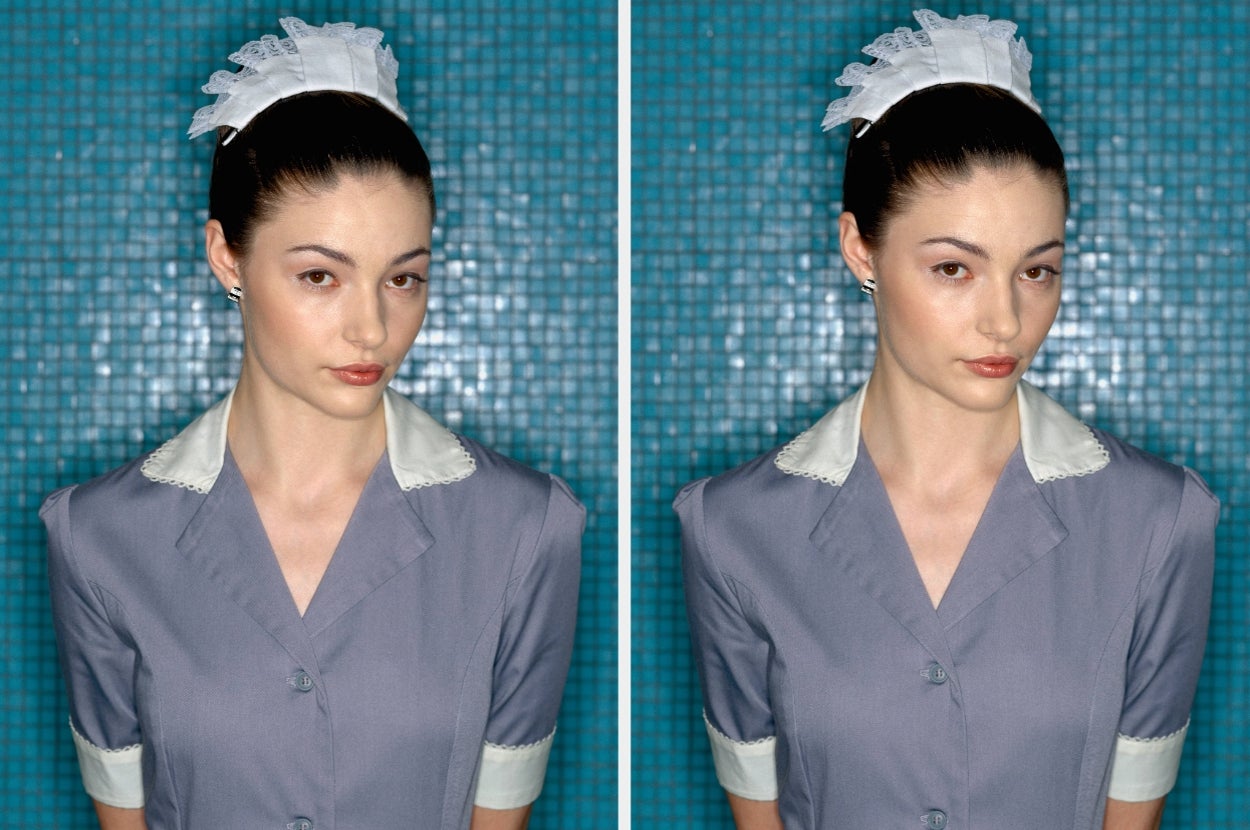 Person wearing a uniform with lace headpiece, standing in front of a tiled background, looking directly at the camera