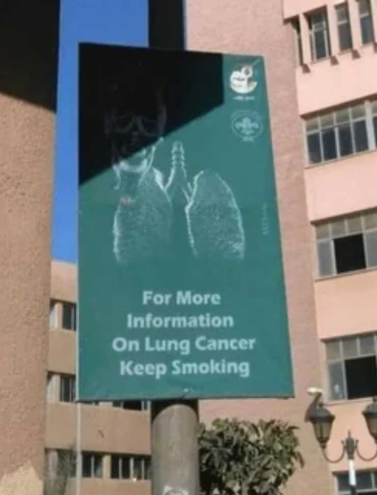 Sign showing chalk-drawn lungs with text: "For more information on lung cancer, keep smoking."