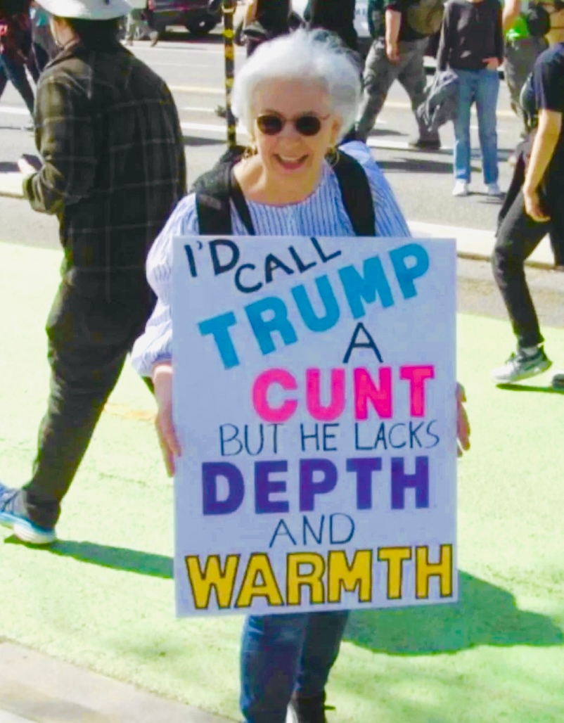 Person holds a protestation  motion   with a captious  connection   astir  Trump, suggesting a deficiency  of extent  and warmth