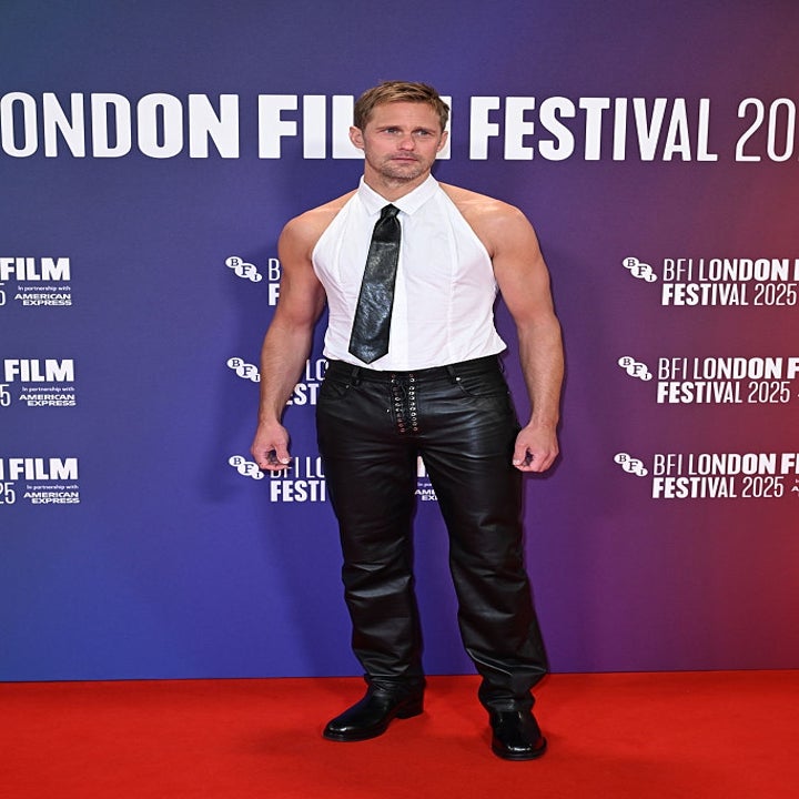 Person on red carpet in a sleeveless shirt with a tie, and leather pants at the BFI London Film Festival 2023