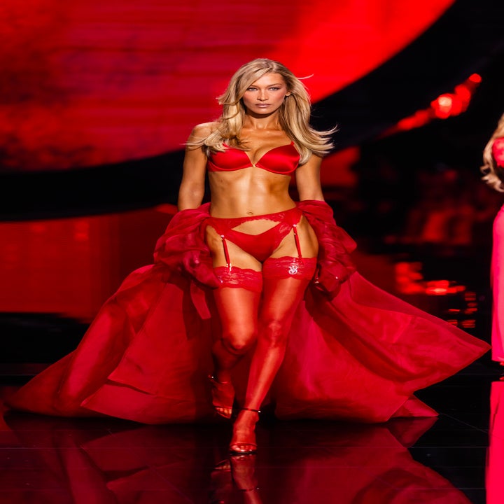 Bella Hadid walking runway in lingerie set with sheer robe and thigh-high stockings
