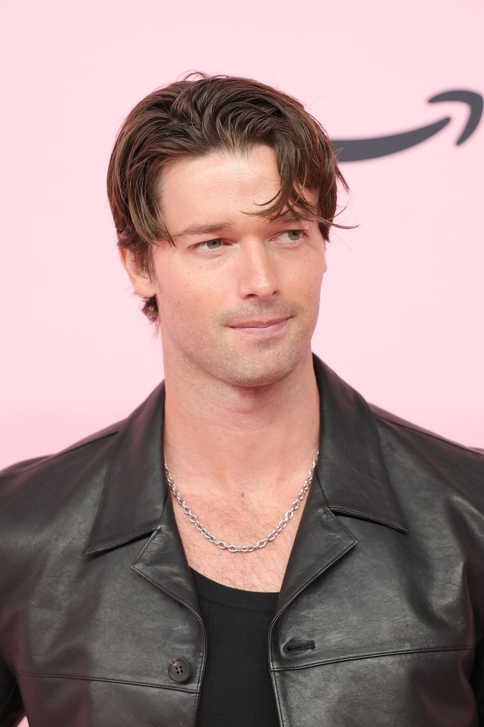 14 Celeb Feuds That Were SO One-Sided, They Were Basically Beefing With A Brick Wall 30 A person at a media event wearing a black leather jacket over a black shirt, with short, styled hair and a silver chain necklace