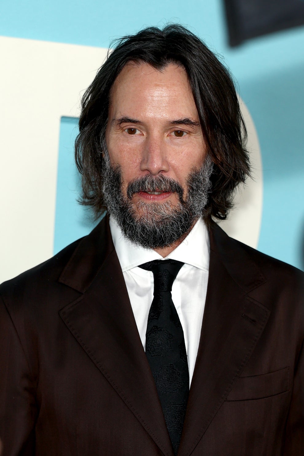 14 Celeb Feuds That Were SO One-Sided, They Were Basically Beefing With A Brick Wall 18 A person with shoulder-length hair and a beard is wearing a dark suit with a black tie at a formal event