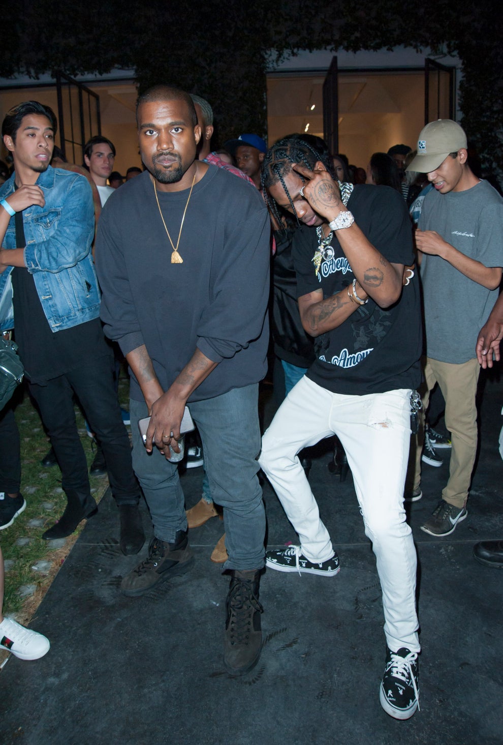 14 Celeb Feuds That Were SO One-Sided, They Were Basically Beefing With A Brick Wall 54 Two individuals are posing at an event. One wears a casual dark outfit, while the other sports a graphic tee and white pants amidst a crowd