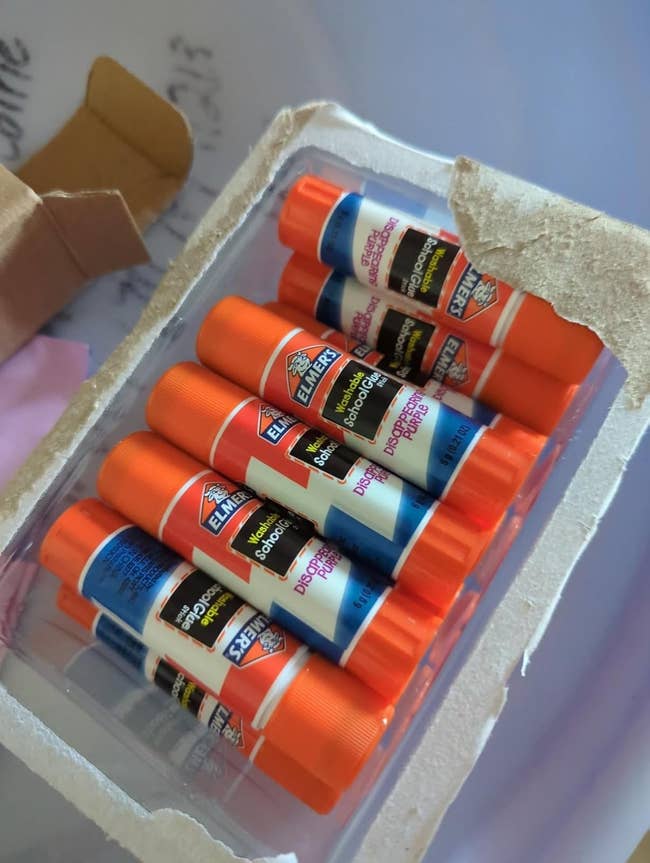 Package of Elmer's School Glue Sticks successful  an unfastened  cardboard box, showing glue sticks inside