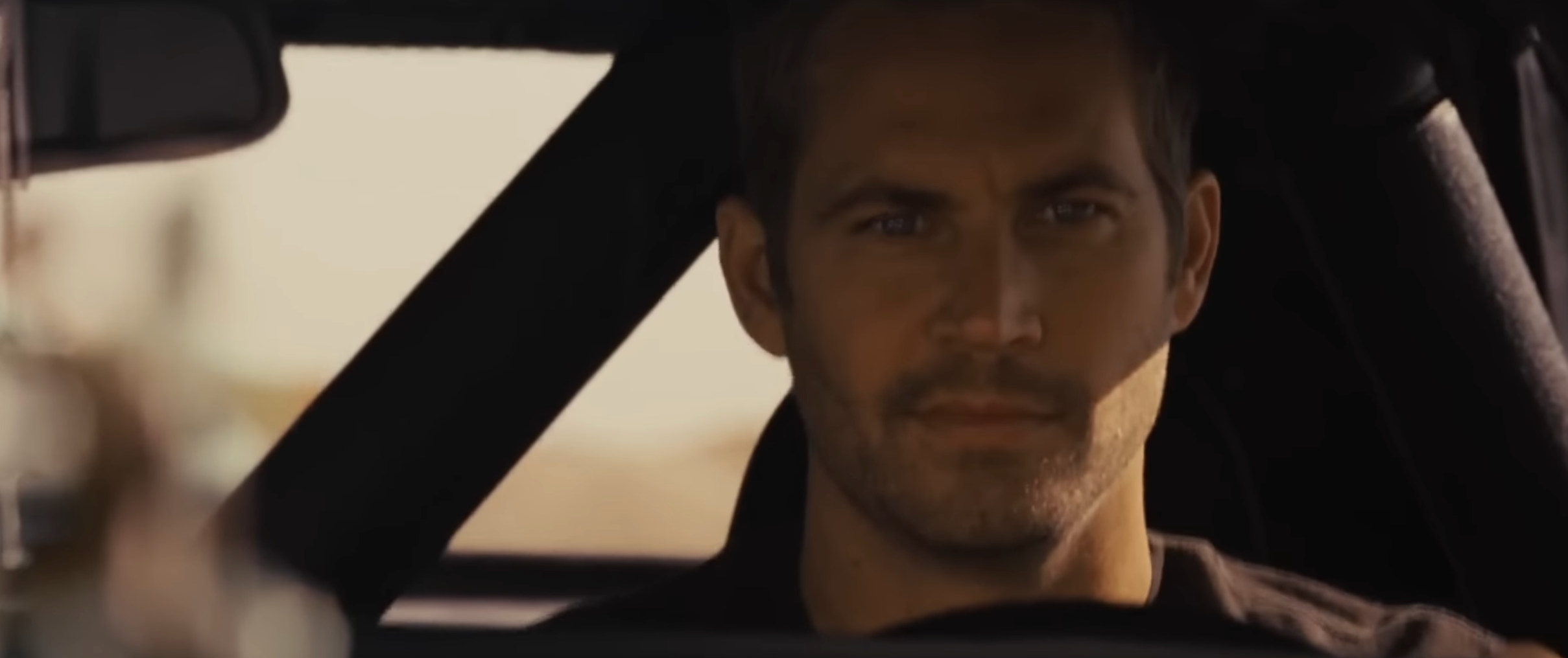 Person driving a car, focused and looking ahead