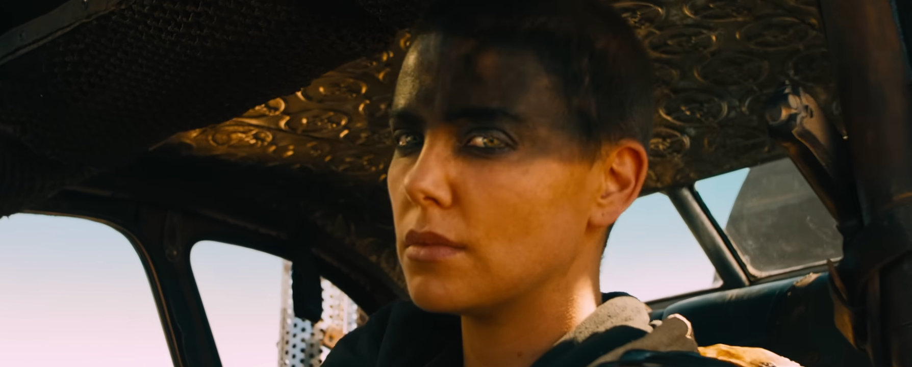 Person with abbreviated  hairsbreadth  and acheronian  oculus  constitution  sitting successful  a vehicle, looking focused. The mounting  suggests a post-apocalyptic theme