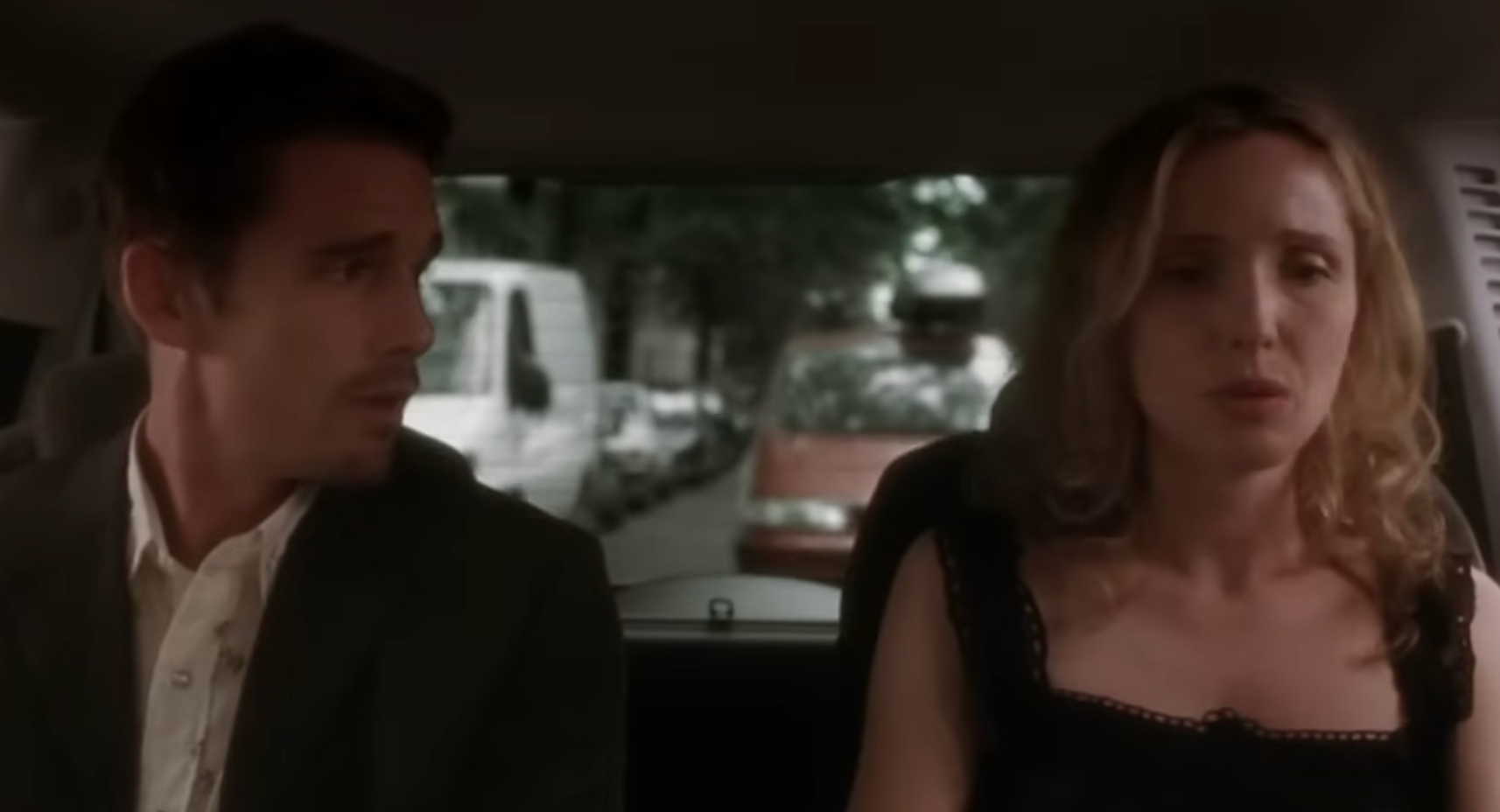 Two radical   beryllium   successful  the backmost  of a car, engaged successful  conversation. The pistillate   wears a sleeveless top