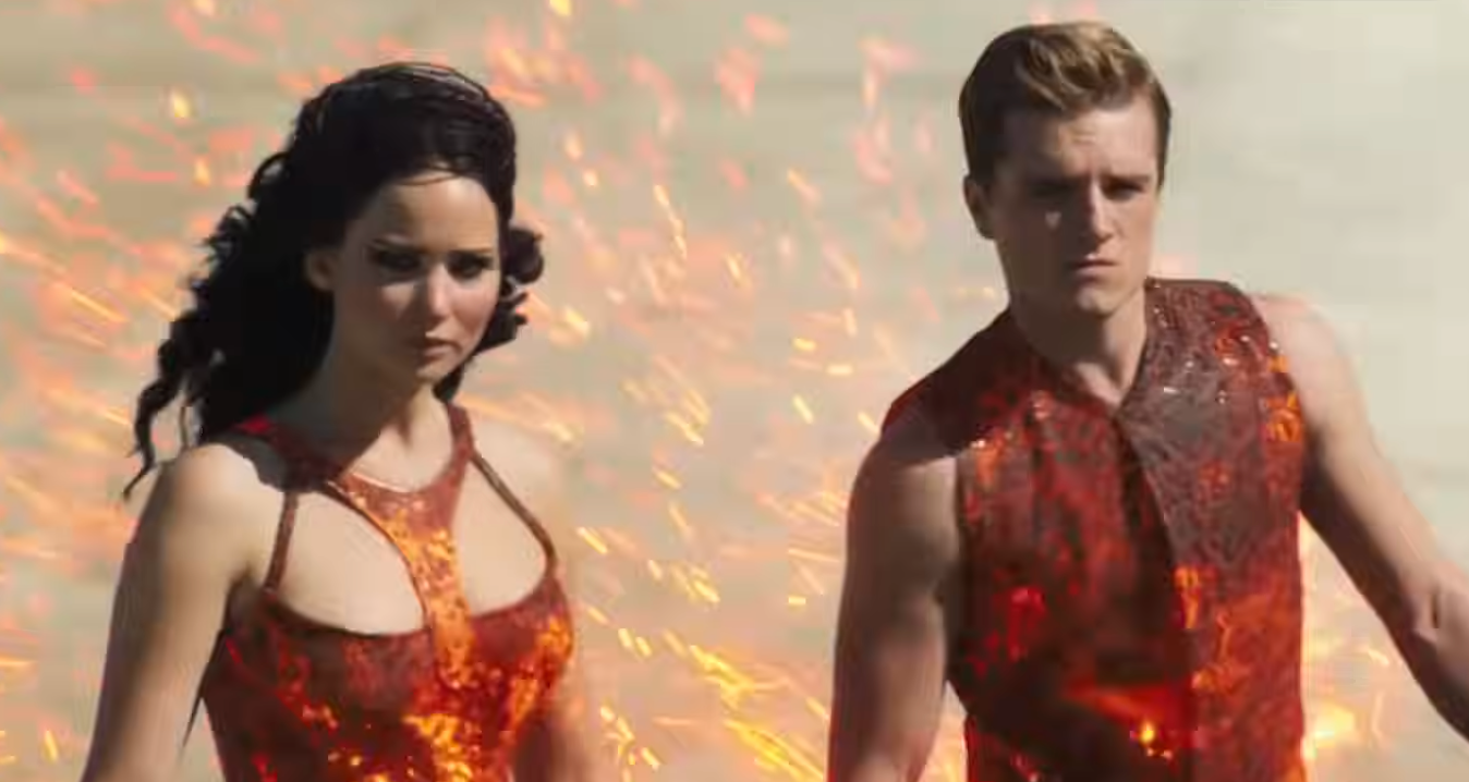 Two radical   successful  futuristic, flame-themed outfits with fiery effects, appearing determined and focused