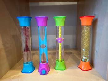Four sensory timer toys with assorted  contents, including glitter and liquid. Ideal for absorption   and accent   relief