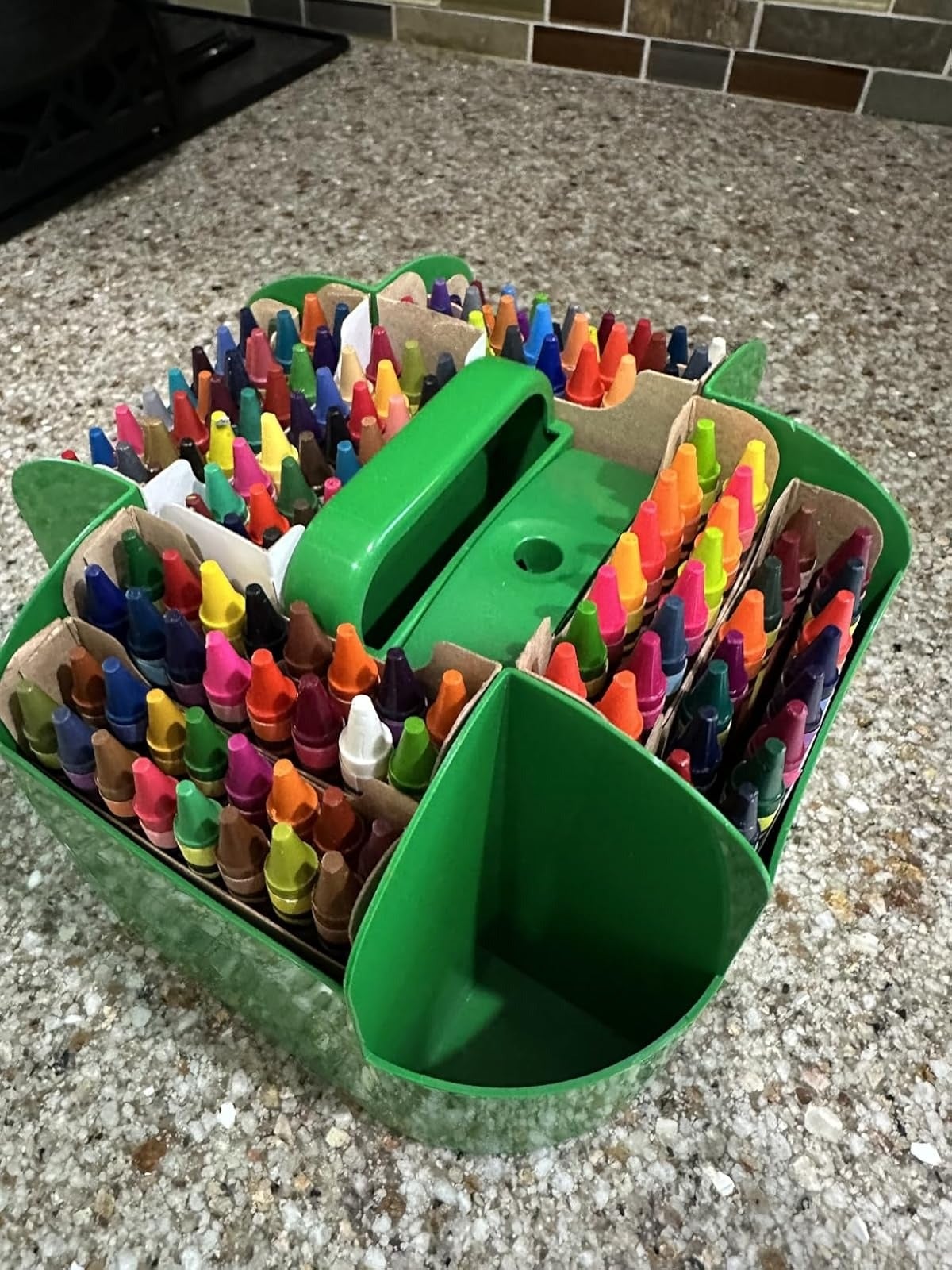 Organized caddy holding assorted  crayons connected  a granite counter, adjuvant  for creation  and trade  buying  choices