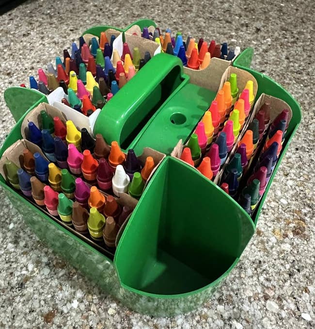 Organized caddy holding assorted crayons connected a granite counter, adjuvant for creation and trade buying choices