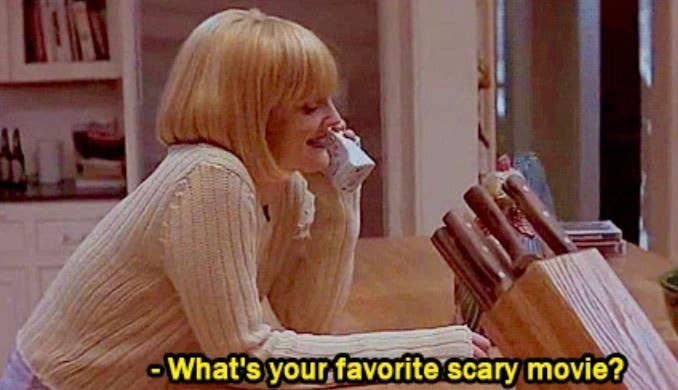 A idiosyncratic   with a abbreviated  bob haircut talks connected  a cordless telephone  successful  a kitchen, with the substance   &quot;What&#x27;s your favourite  scary movie?&quot; displayed below