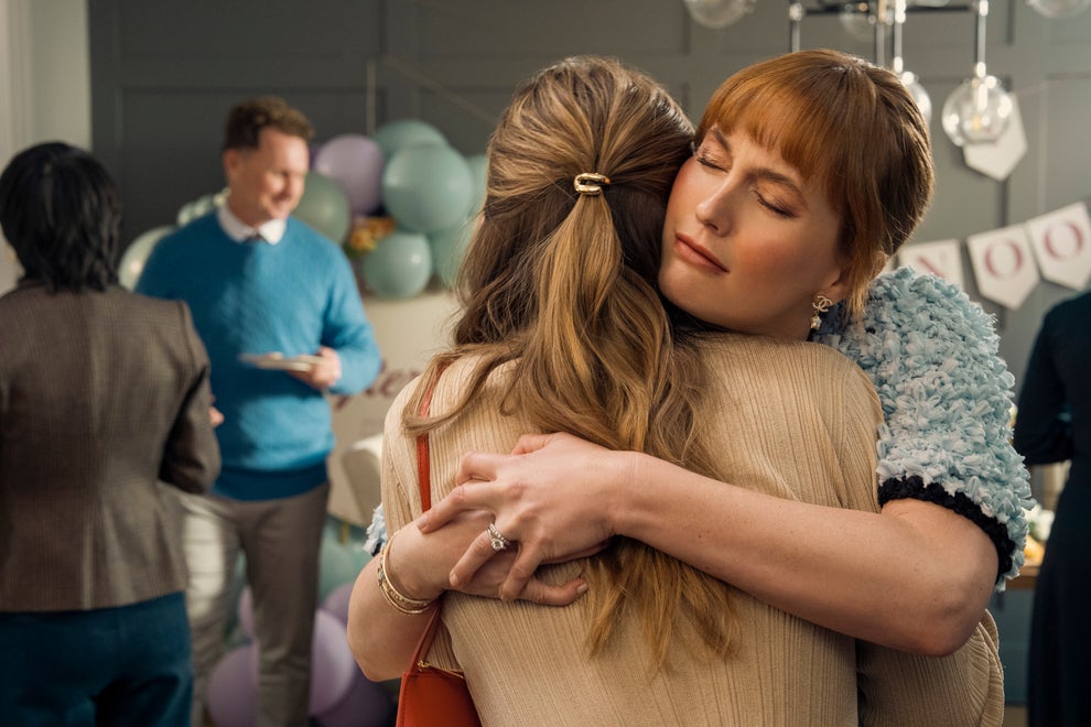 Here's A Show And Movie You Need To Watch This Weekend, Plus More TV And Movie News You Might've Missed 9 Two people warmly embrace at a social gathering, with others chatting in the background
