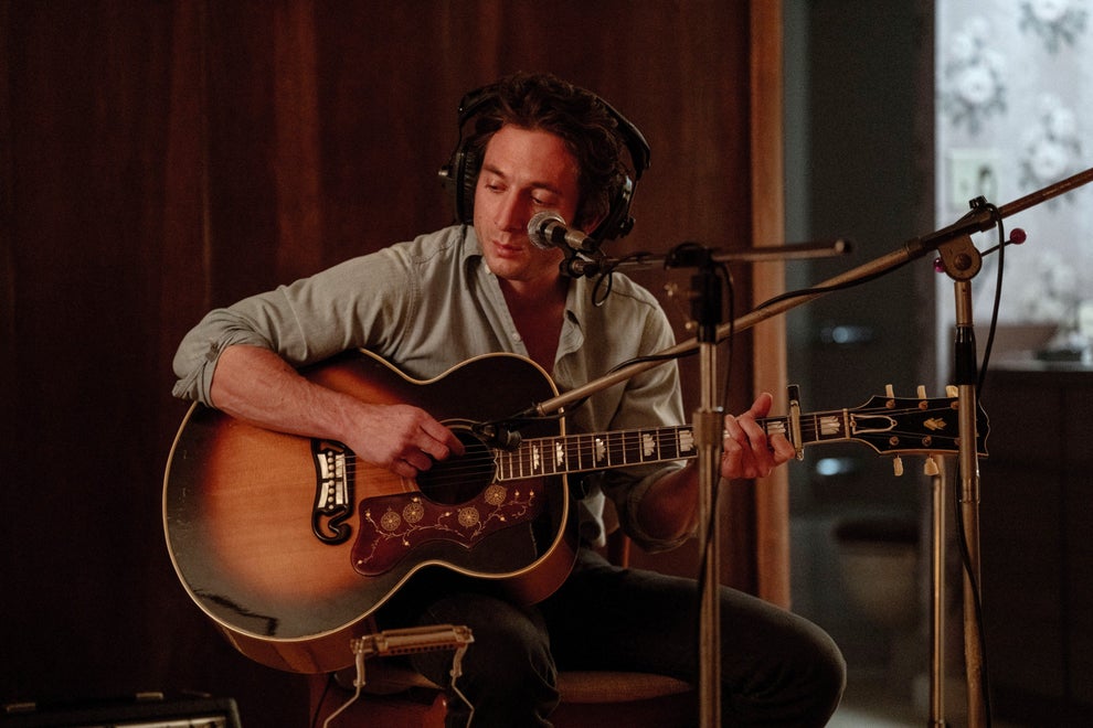 Here's A Show And Movie You Need To Watch This Weekend, Plus More TV And Movie News You Might've Missed 13 Musician playing guitar and singing into a microphone in a recording studio, wearing headphones and a casual button-up shirt