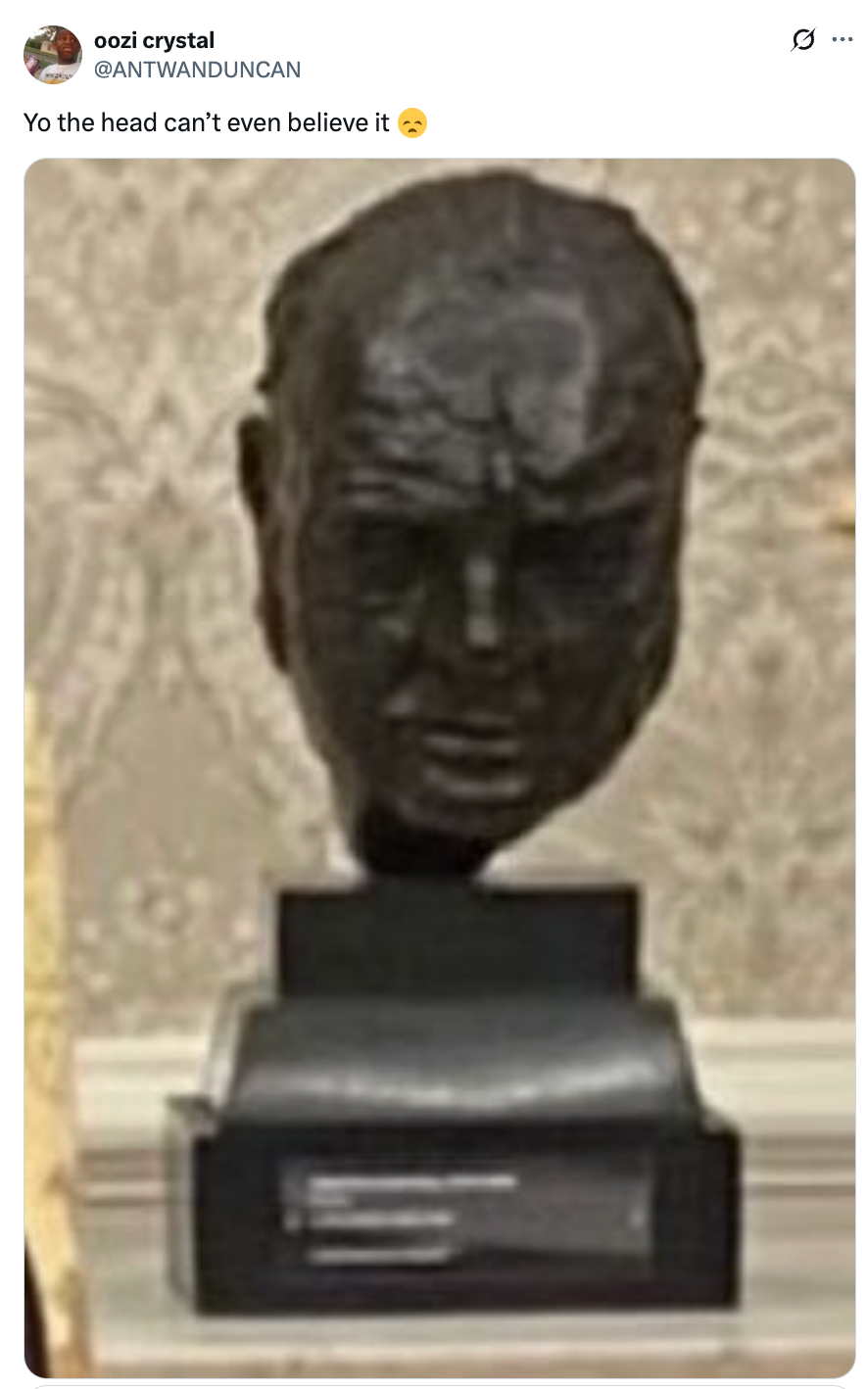 A sculpture of a head with a caption above it saying, &quot;Yo the head can’t even believe it,&quot; followed by a pensive face emoji