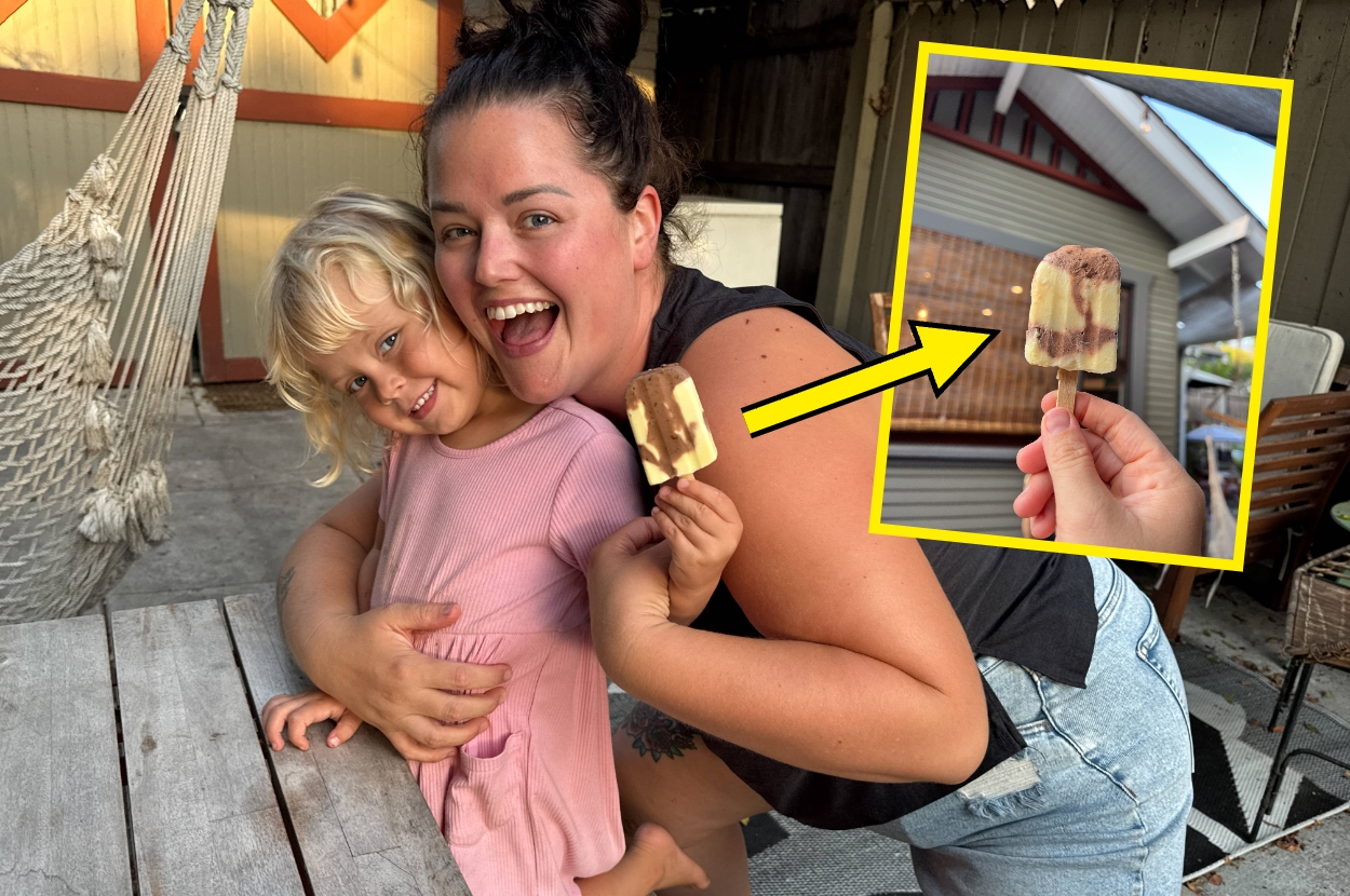 A smiling adult and child enjoy chocolate and vanilla ice creams outdoors