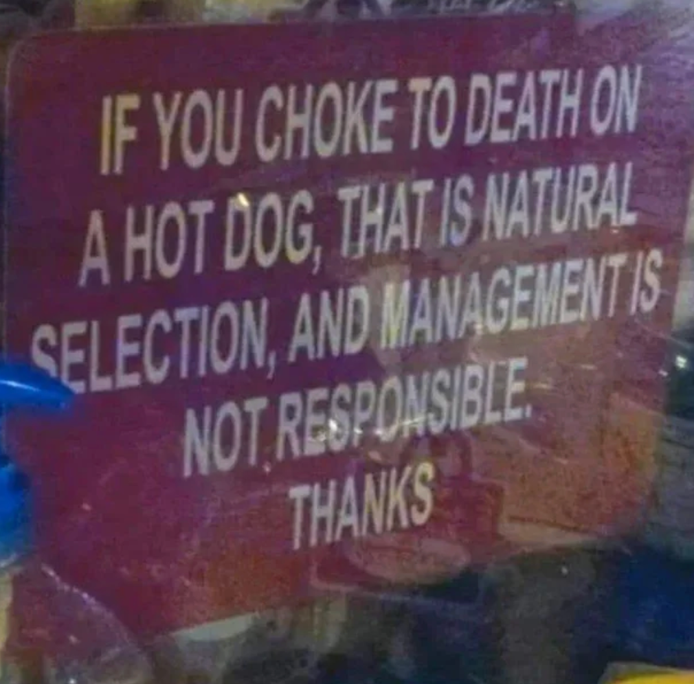 Sign reads: "If you choke to death on a hot dog, that is natural selection, and management is not responsible. Thanks."