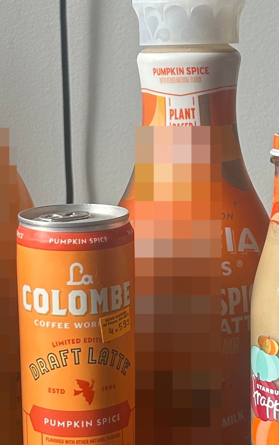 Six pumpkin spice-flavored coffee drinks from different brands are displayed on a table