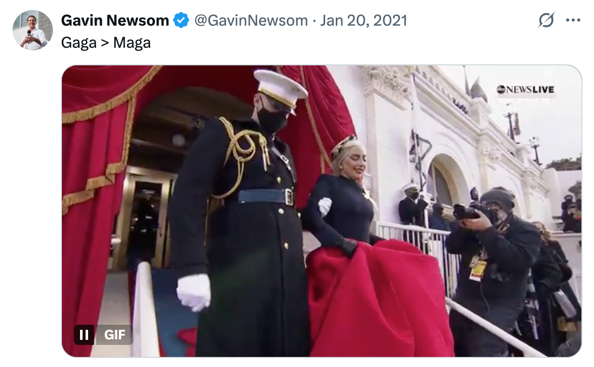 Lady Gaga in elegant gown at President Biden's 2021 inauguration, accompanied by military personnel