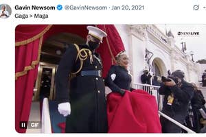 Lady Gaga in elegant gown at President Biden's 2021 inauguration, accompanied by military personnel
