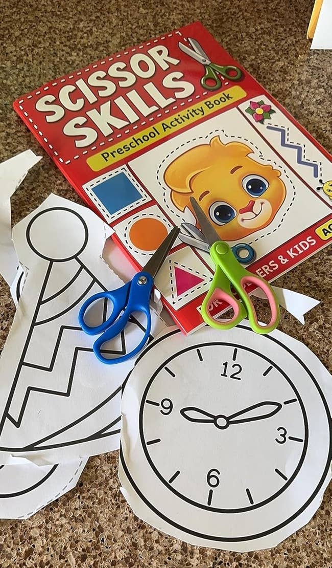 Activity publication and cutout shapes with a timepiece and enactment hat. Scissors nearby. Ideal for honing preschoolers' cutting skills